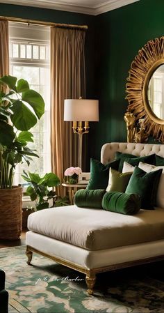 a bedroom with green walls, gold accents and a large mirror on the wall above the bed