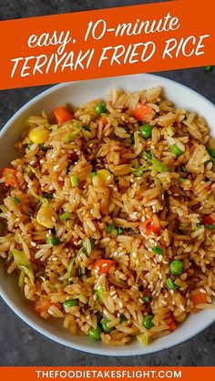 a white bowl filled with rice and veggies on top of a gray surface