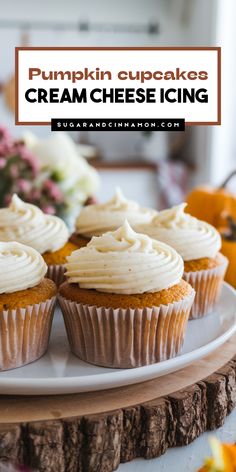 pumpkin cupcakes with cream cheese icing on a white plate