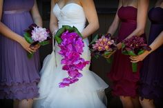 the bridesmaids are holding their bouquets with purple and pink flowers in them