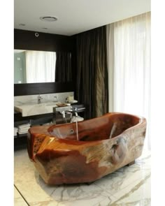 a large wooden bathtub sitting on top of a bathroom floor