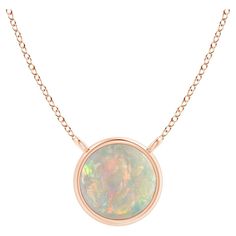 Featuring a simple yet elegant design, this 18k rose gold opal solitaire necklace is sure to fascinate. The bezel set cabochon opal allures with its delightful play of colors. Available in different carat weight. Opal is the Birthstone for October and traditional gift for 12th & 14th wedding anniversaries. Free Certificate of Authenticity. All items are packaged with care in appealing boxes with plush interiors. Bezel Set Cabochon, Handmade Silver Jewellery, Solitaire Necklace, Sapphire Solitaire, Round Solitaire, Raw Opal, Garnet Pendant, American Modern, Solitaire Necklaces