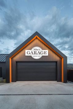 a garage with the words garage on it's side and an orange light at the top