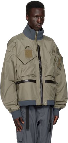 GORE-TEX® 3L nylon ripstop bomber jacket. · Windproof, water-repellent, breathable, and lightweight · GORE-TEX® stretch laminate stand collar, hem, and cuffs · Zip closure · Zip pockets · Velcro tabs at front and sleeves · Concealed bungee-style drawstring at hem · Zip expansion panel at sides seams · Flap pocket at sleeve · Locker loop at back collar · Detachable elasticized shoulder strap at interior · Taped seams · Unlined · Includes studded and logo-printed velcro tape Supplier color: Alpha