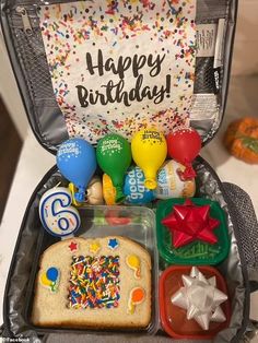 a suitcase filled with lots of food and confetti on top of it's lid