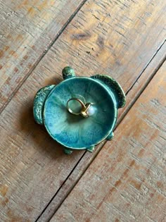 a ring dish sitting on top of a wooden table