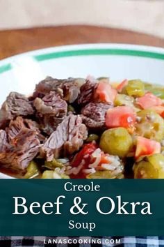 a white plate topped with beef and okra next to a bowl of olives