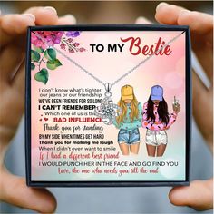 two girls holding up a card with the words to my bestie