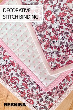 three pieces of pink and white fabric sitting on top of a wooden floor