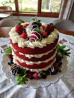 a red velvet cake with strawberries and chocolate covered strawberries on the top layer