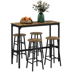 the table has four stools and a vase with flowers on it, along with three barstools