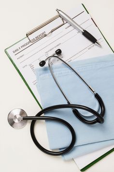 a stethoscope sitting on top of medical paperwork