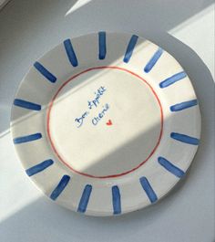 a white plate with blue and red designs on it