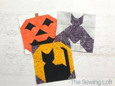 three pieces of quilted fabric with pumpkins and bats on them