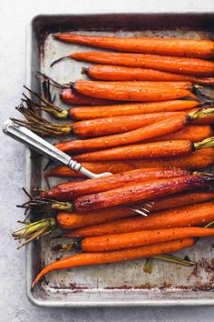 carrots are sitting on a baking sheet and ready to be cooked in the oven