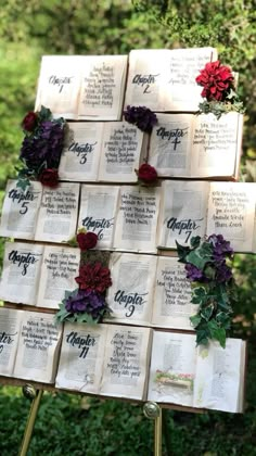 an arrangement of books with flowers on them are arranged in the shape of a tree