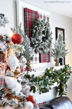 the christmas tree is decorated with red and white ornaments, pine cones, holly wreaths, and other holiday decorations