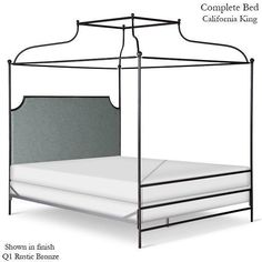 the canopy bed is made up with white sheets and gray headboard, along with pillows