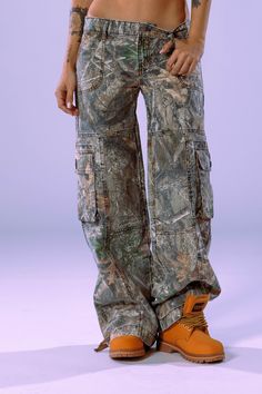 DESCRIPTIONThe Amelia Pant in Oakland is the perfect mix of the classic camo cargo and parachute pant. Featuring a low rise fit and relaxed legs. The Amelia Pants are perfect for a day in or a night out. DETAILSSuper Low-Rise Style Baby Parachute 6-Pocket Design3D Cargo PocketsAdjustable Drawstrings24" Leg Opening32-35" Inseam100% Cotton Model is 5'9 (1) & 5'7 (2) wearing size 25 Our current fabric runs 1 size small, we recommend sizing up 1 size. At Revice Denim, our aim is to contribute to environmental conservation by utilizing sustainable dead-stock fabric. We are committed to preserving the authentic washes of our denim while acknowledging that each batch may exhibit slight variations from one another from wash to print. Harlem Fashion, Cargo Pants Aesthetic, Amsterdam Outfit, Revice Denim, Parachute Pant, Environmental Conservation, Camo Cargo Pants, Fall Fits, Camo Pants