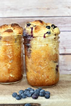 two jars filled with blueberry french toast in a jar next to fresh blueberries