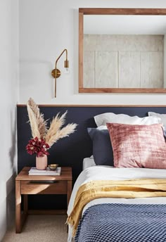 an instagram photo of a bedroom with a bed and mirror on the wall above it