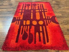 a red and orange area rug on the floor