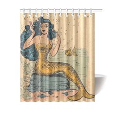 a shower curtain with a mermaid sitting on a rock