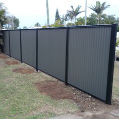 a fence that is next to some grass