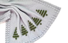 a white scarf with green leaves on it