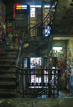 a stairwell with graffiti on the walls and stairs