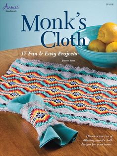 the book monk's cloth is sitting on a table with lemons in a bowl