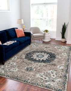 a living room with a couch, chair and rug