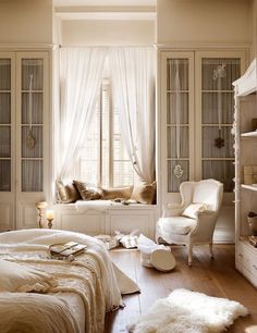 a bedroom with white furniture and curtains on the windowsills is pictured in this image