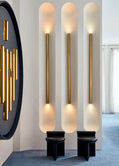 three tall white and gold sculptures in a room