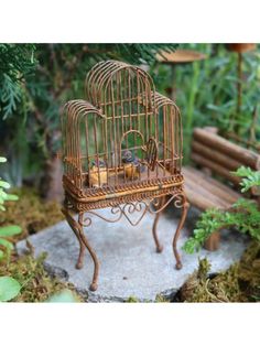 a miniature bird cage with small birds inside