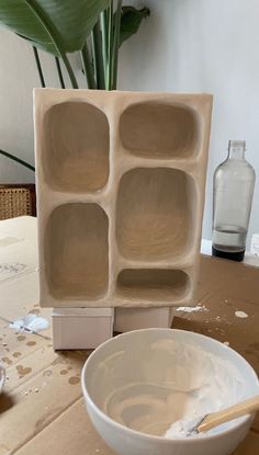 a white bowl sitting on top of a wooden table