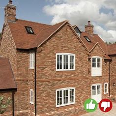 a brick house with thumbs up signs in front