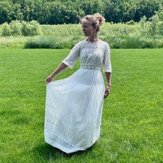 Gorgeous antique 1910s whitework embroidered sheer white cotton lawn and cutwork lace dress. I adore these dresses and they are perfect for the summer. This one is pictured with an additional white cotton petticoat skirt underneath (not included in sale). Styled with a scalloped embroidered neckline featuring cutwork lace trimming the shoulders, bust, half length sleeves and waist. Whitework embroidery on the sheer white cotton lawn in a floral design. Fitted through the bust and waist with a sweeping full skirt styled with tuck seams at the top portion. The dress closes with hook/eyes up the back along with some extending into the top skirt.  Best Fit: XS - XS/S Bust: 34" Waist: 25" can pull to 26" max Hip: Free Length: 54 1/4" Condition: Good- / Freshly Cleaned / Ready to Wear! Can defin Vintage White Dress With Scalloped Lace, Vintage Lace Dress With Scalloped Detail, White Cotton Lace Dress With Scalloped Details, Vintage White Victorian Dress With Broderie Anglaise, Cotton Lawn Dress, Whitework Embroidery, Cutwork Lace, Petticoat Skirt, Edwardian Insertion Lace Dress