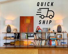 there is a book shelf with many books on it in front of a wall that says quick ship