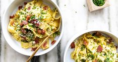 two bowls of pasta with bacon and parsley on the side next to a small bowl of broccoli