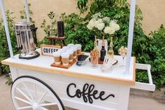 an outdoor coffee cart with drinks on it