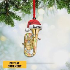 a christmas ornament with a trumpet on it's side hanging from a tree