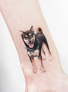 a small dog tattoo on the wrist