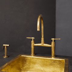 a gold sink and faucet in a bathroom