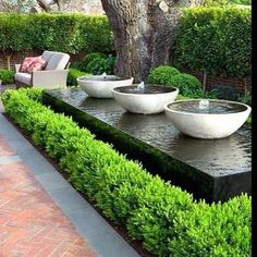 some white bowls sitting on top of a water feature