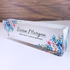 a clear box with flowers on it sitting on a table