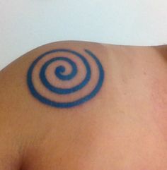 a man with a tattoo on his shoulder has a blue spiral design on it's back