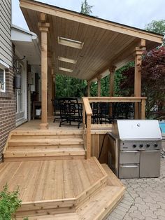 an outdoor kitchen and grill area on a deck