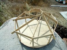 a wooden structure sitting on top of a cement slab