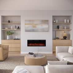 a living room with white furniture and a fire place